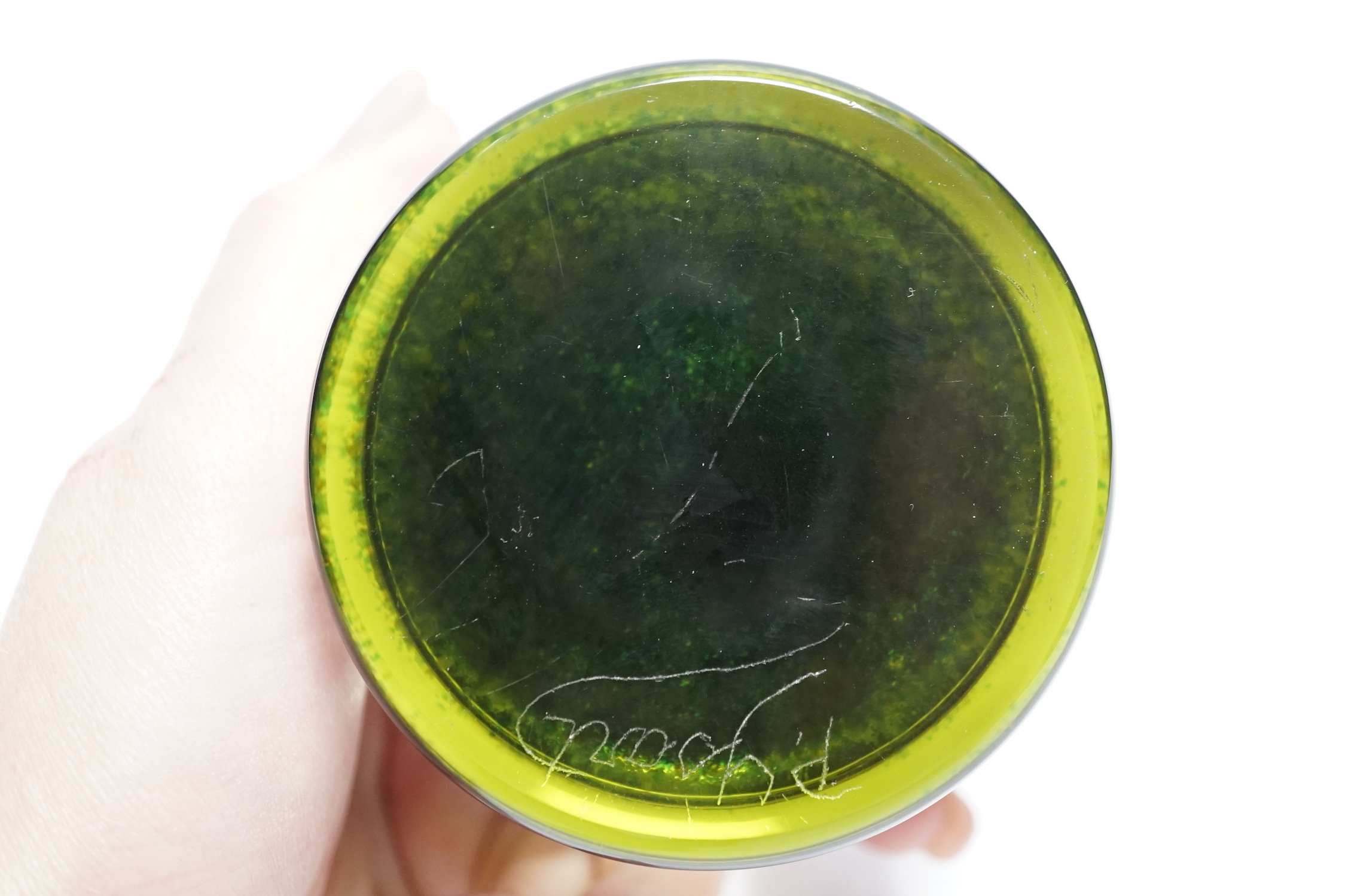 A rare Paul Ysart ‘insect and flower’ footed glass paperweight, Caithness period, scratched signature ‘P. Ysart’, ‘PY’ cane, decorated with a butterfly and pink dahlia, blue jasper ground, raised on a dark green glass fo
